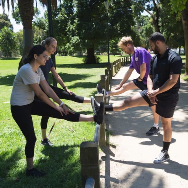 Premier Sports Medicine practitioners guiding runners through exercises outdoors